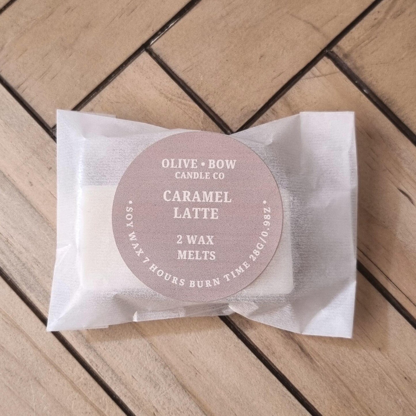 2 Pack of Olive & Bow Candle Co Caramel Latte soy wax melts on a wooden surface