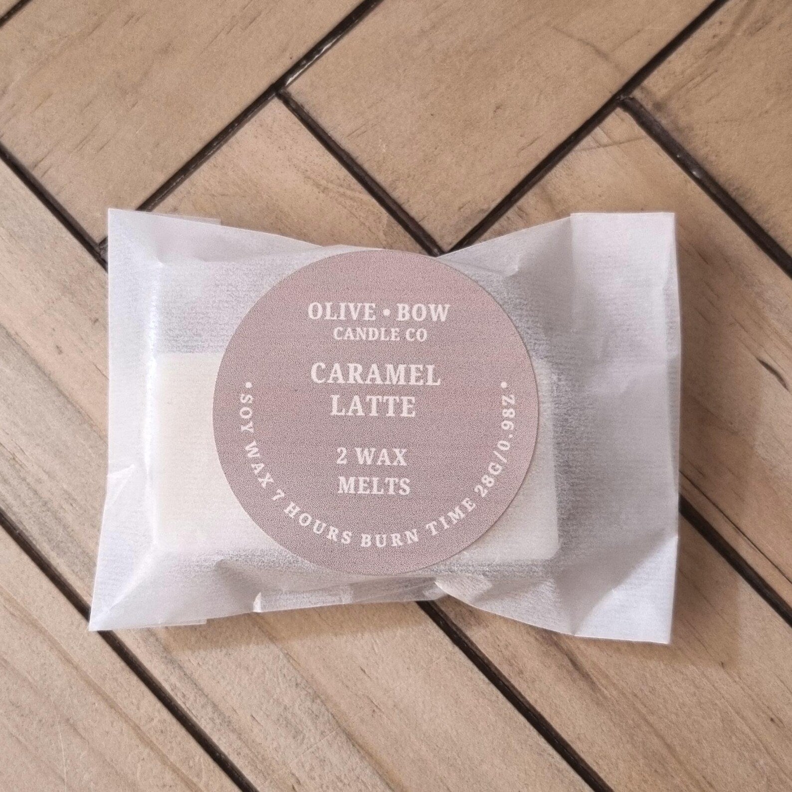 2 Pack of Olive & Bow Candle Co Caramel Latte soy wax melts on a wooden surface