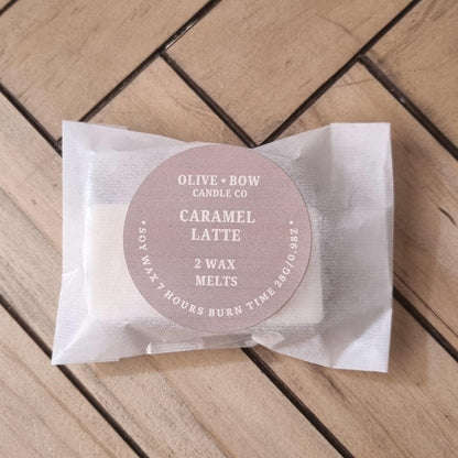 2 Pack of Olive & Bow Candle Co Caramel Latte soy wax melts on a wooden surface