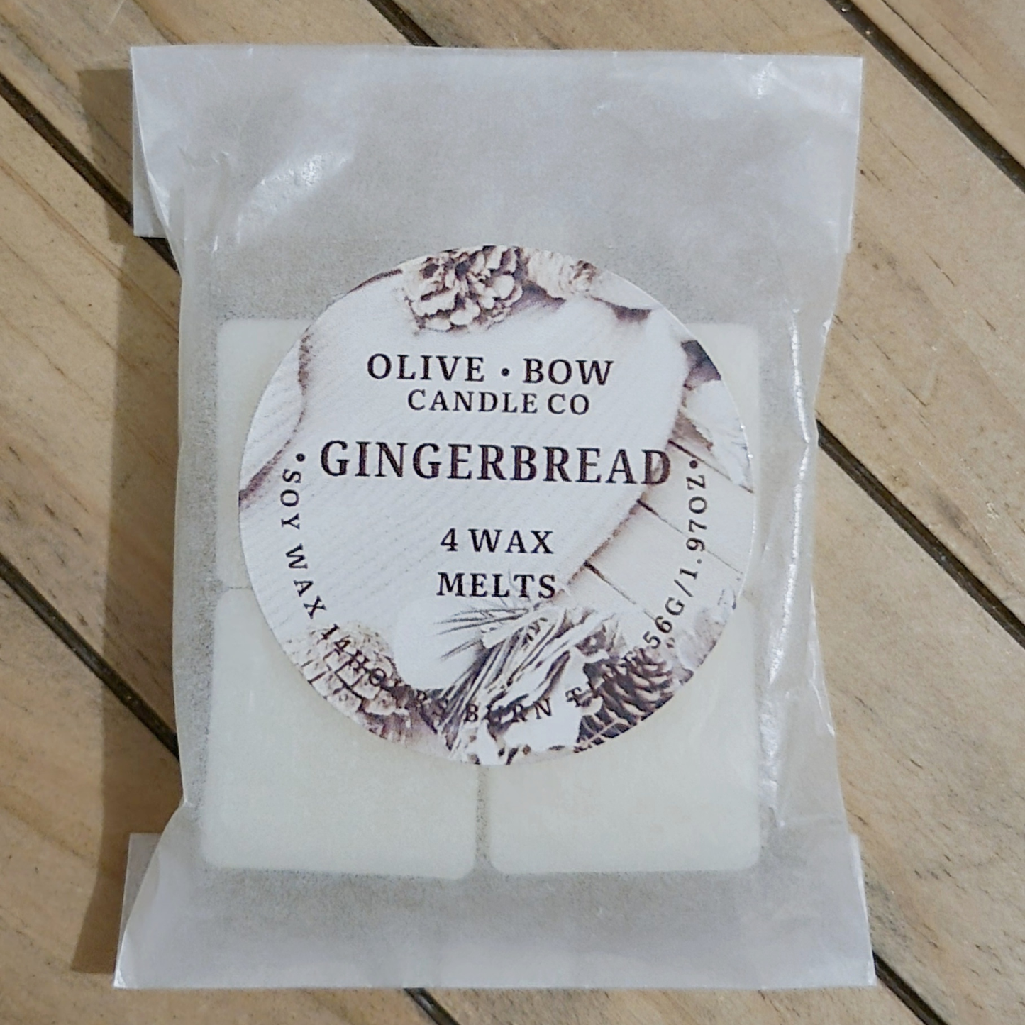 4 Pack of Olive Bow Candle Co gingerbread soy wax melts on a wooden surface