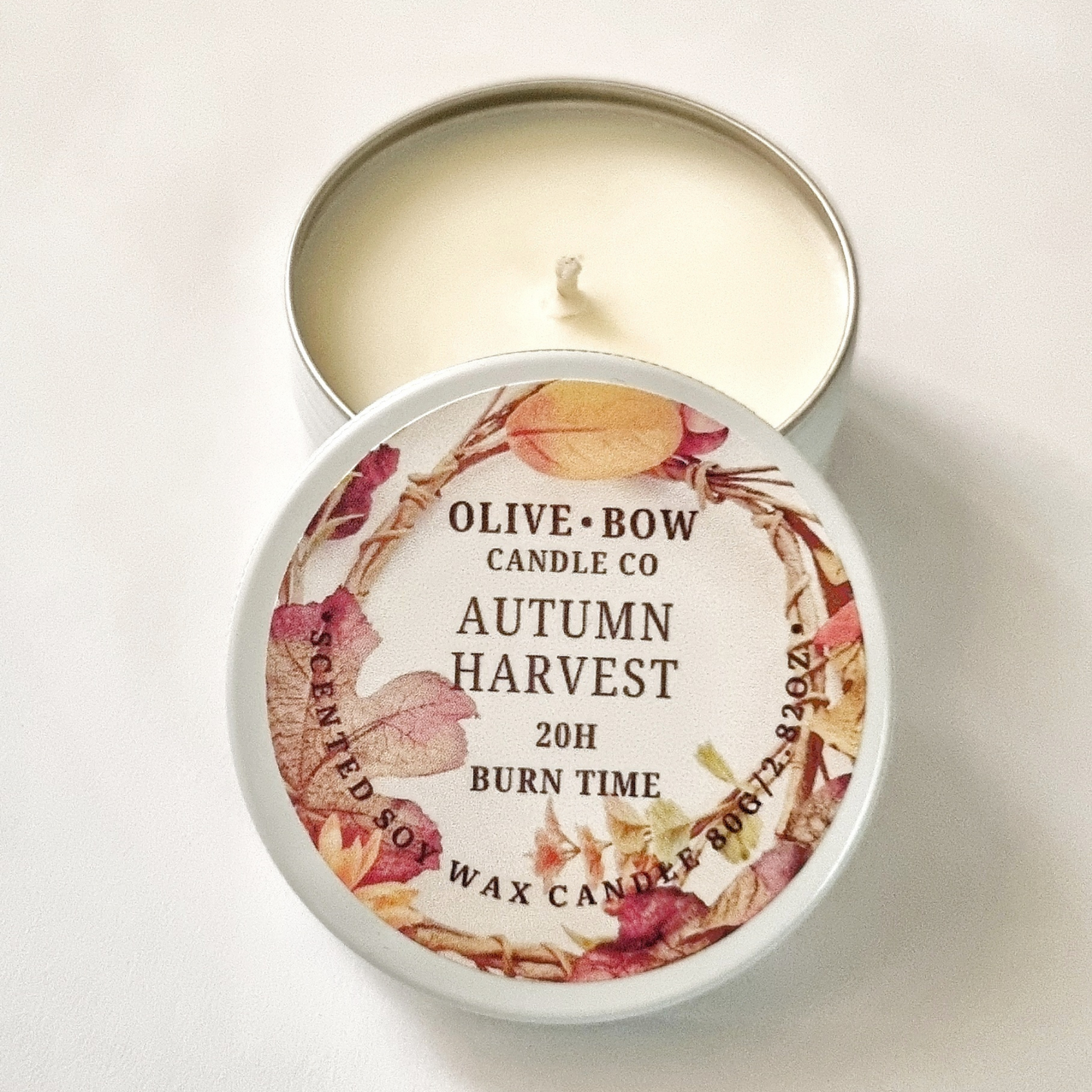 Olive Bow Candle Co autumn harvest soy candle in a tin on a white background