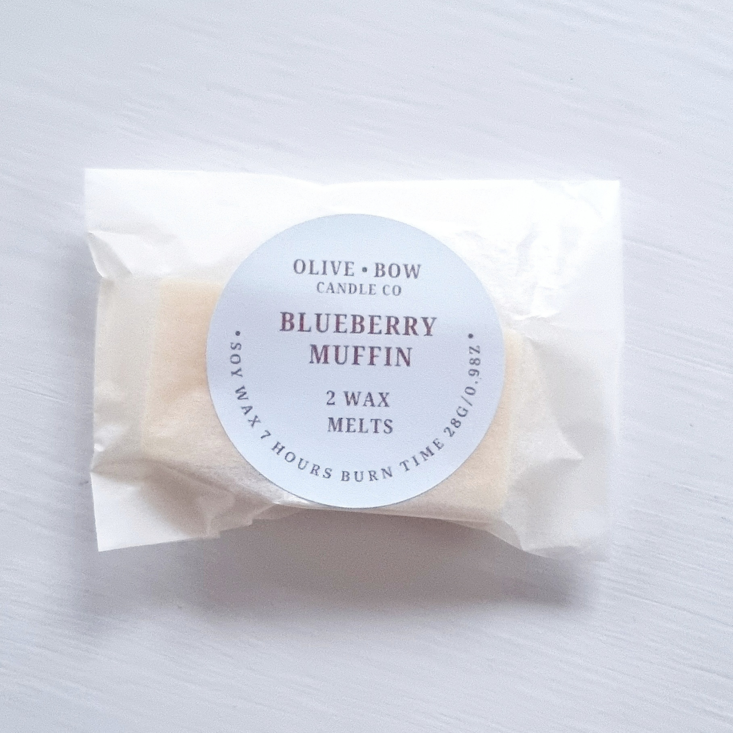 Pack of wax melts labeled 'Blueberry Muffin' by Olive & Bow Candle Co on a white background