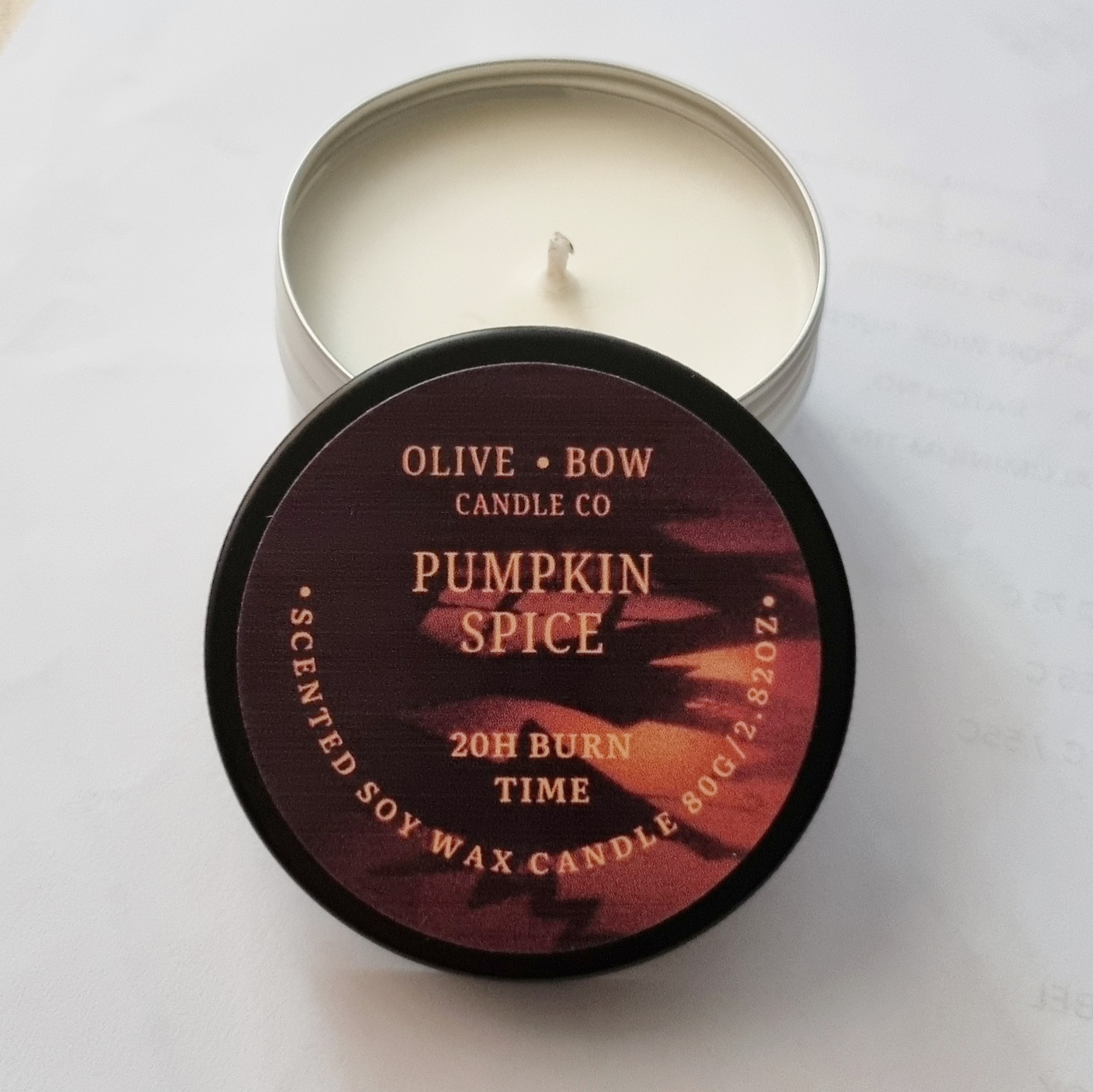 Olive Bow Candle Co pumpkin spice soy candle with lid on a white background