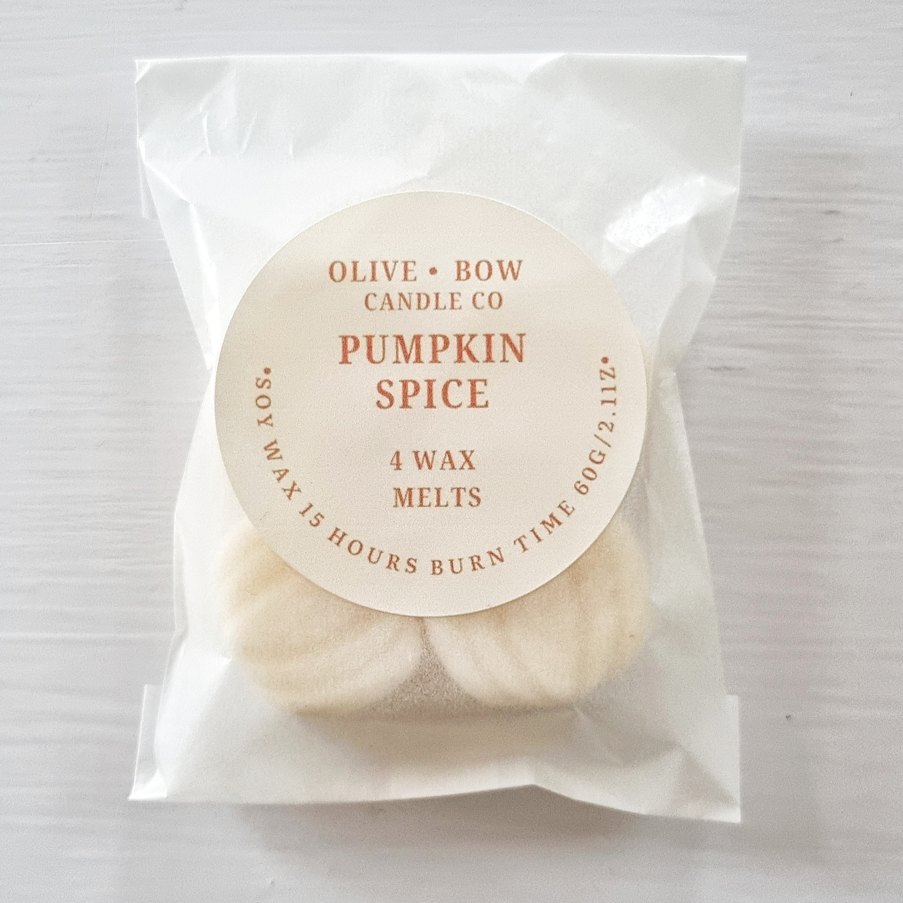 Packaged soy wax melts with 'Olive Bow Candle Co' label on a white background with the scent 'Pumpkin Spice'